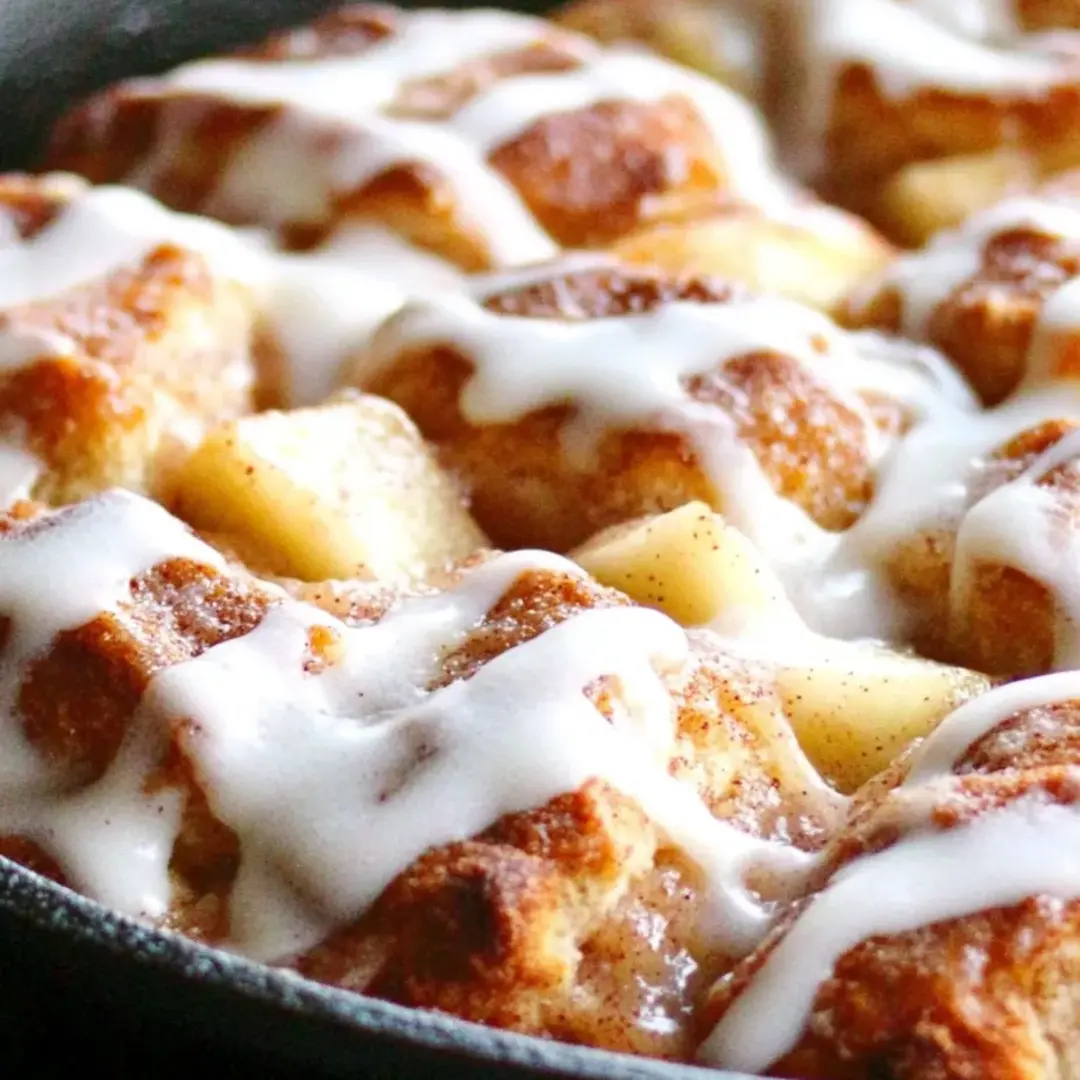 A pan of cinnamon rolls with white icing.