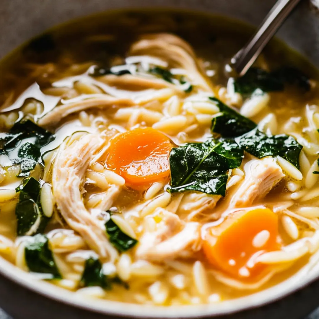 A steaming bowl of chicken vegetable soup.