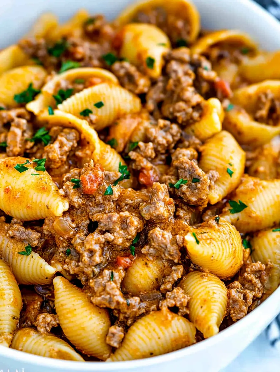 A bowl of pasta with meat and vegetables.