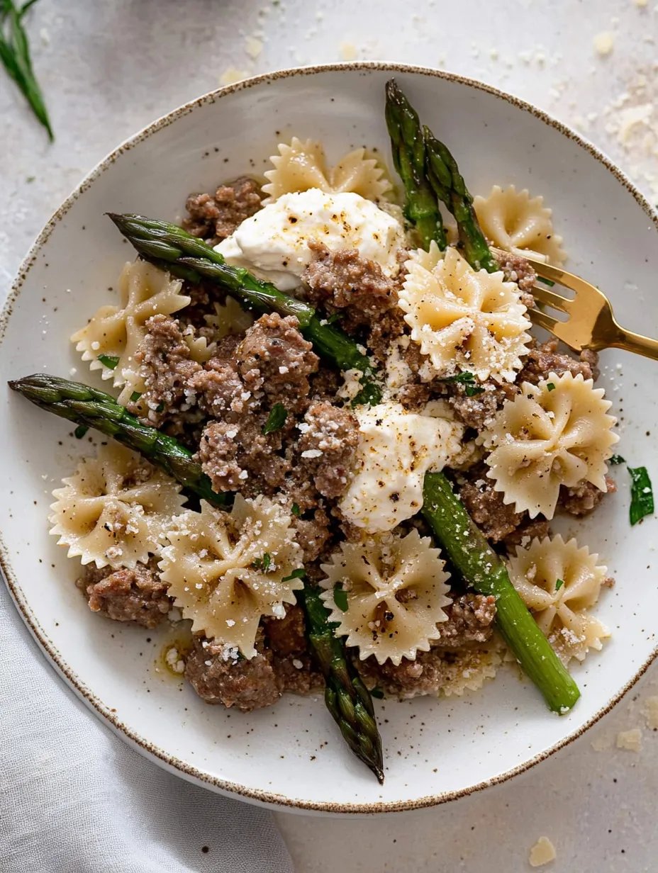 A plate of pasta with meat and cheese.