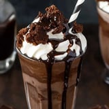 A chocolate milkshake with whipped cream.