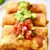 A plate of food with salsa on top.