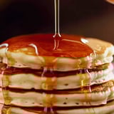 Syrup pouring onto a pancake stack.