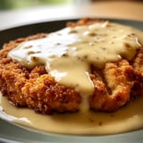 A plate of Chicken Fried Steak with Gravy.