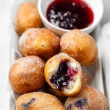 A bowl of jelly filled doughnuts.