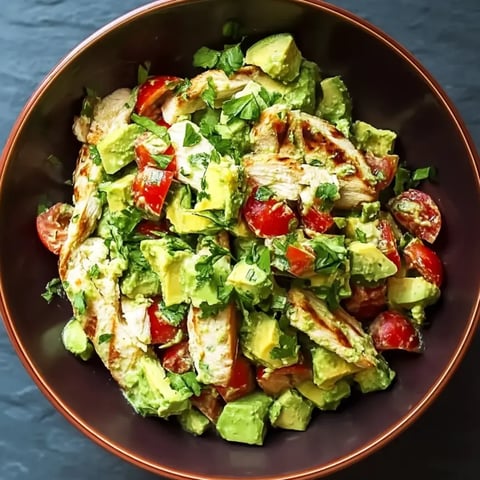 A bowl of chicken and avocado salad.