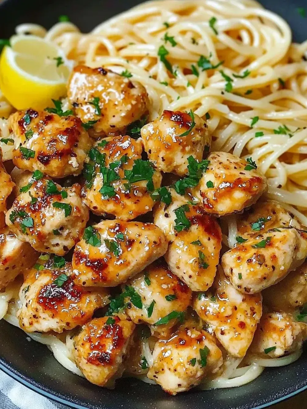 A plate filled with chicken and noodles.