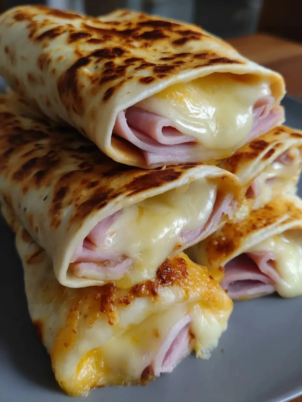 A stack of sandwiches with cheese and ham.