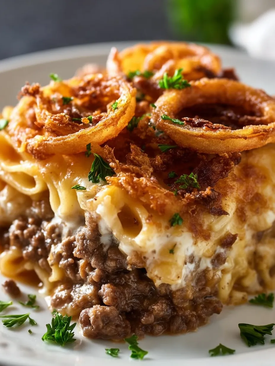 Plate with hearty noodles piled alongside beef and golden onions.