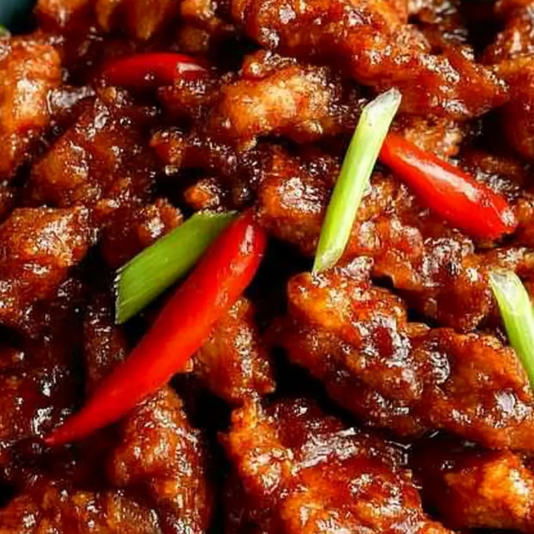 Chicken with peppers on a plate, bursting with color.