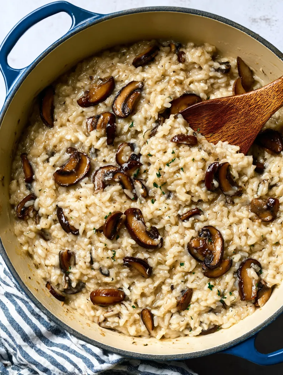 A bowl of rice with mushrooms and herbs.