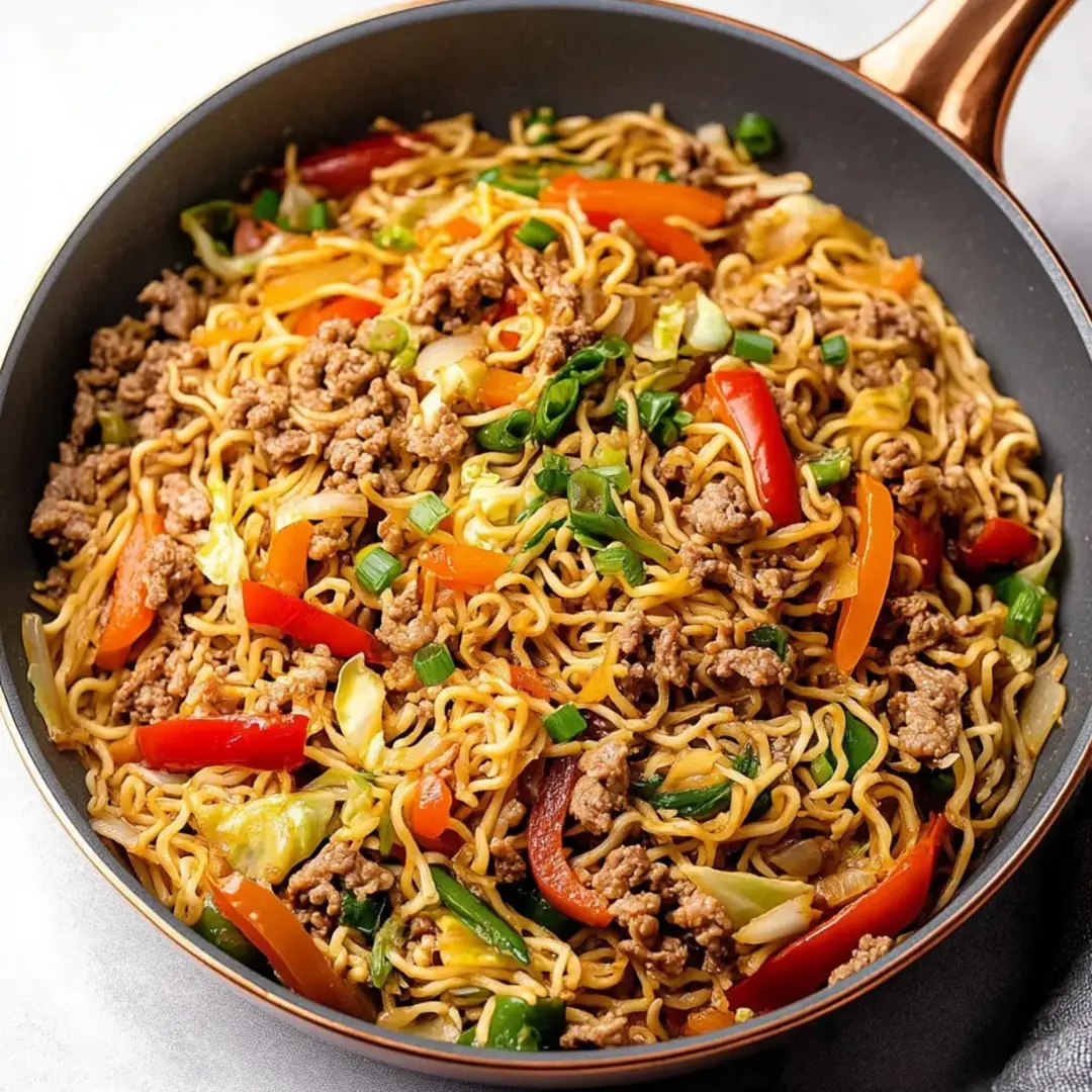 A bowl loaded with noodles, veggies, and chicken.