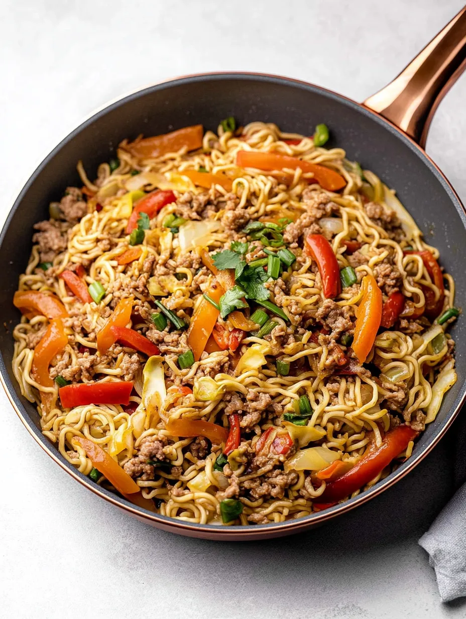 A bowl of noodles with vegetables.