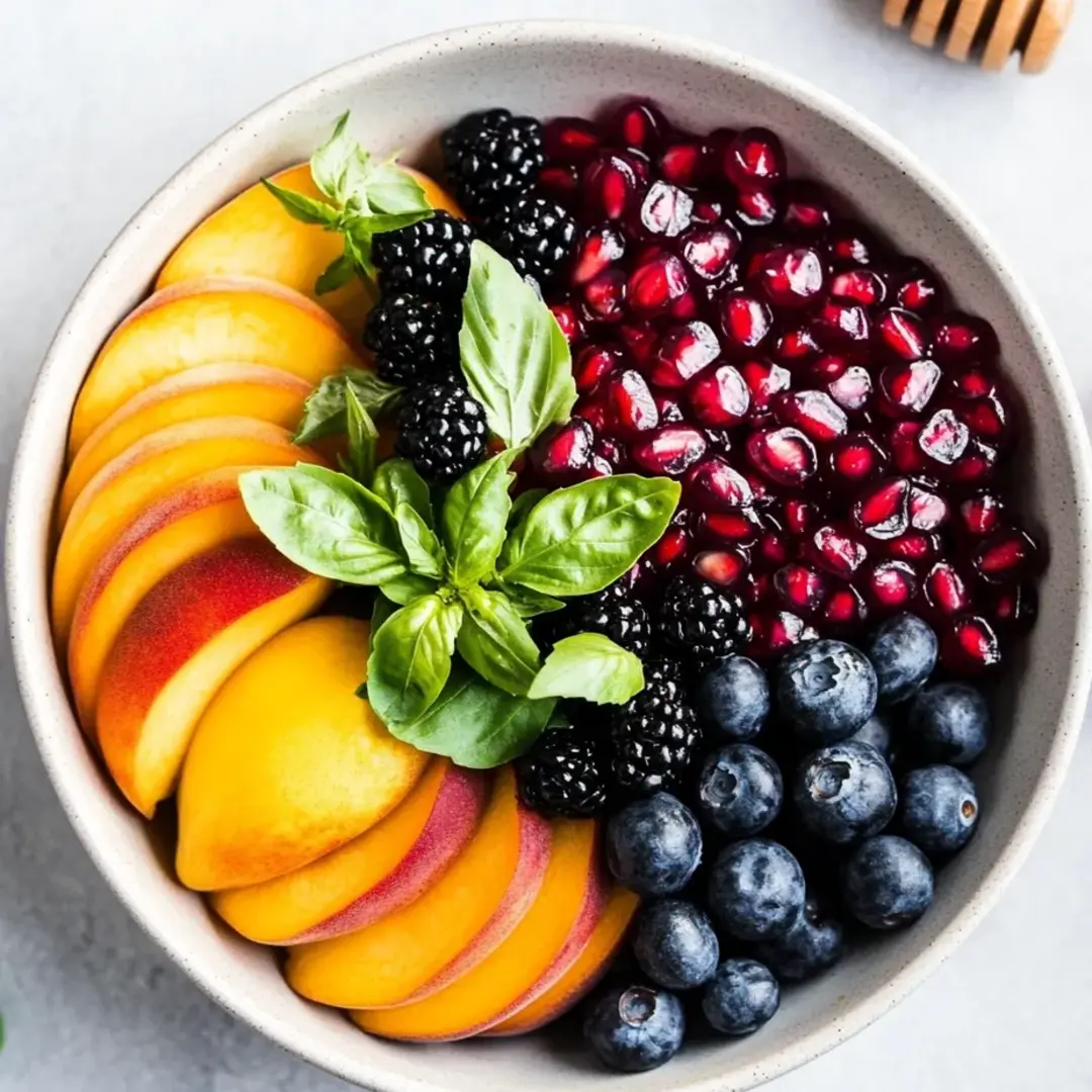 A bowl packed with blackberries, raspberries, and blueberries all mixed together.