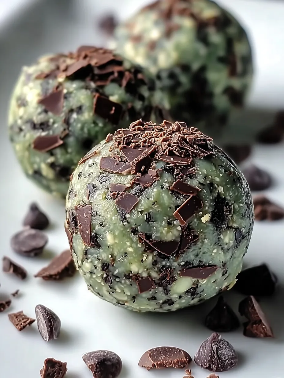 Two chocolate covered green treats sitting together.