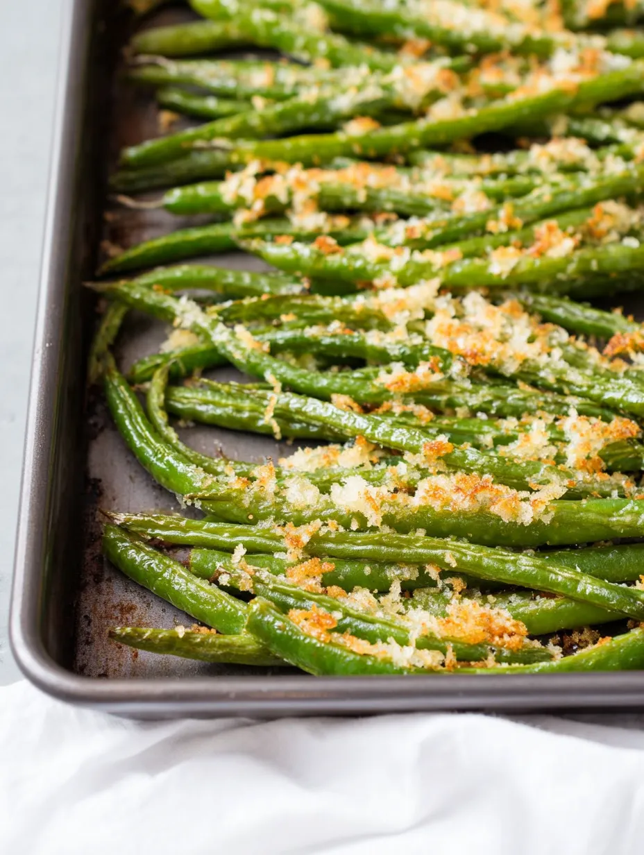 A pan of green beans with cheese on top.