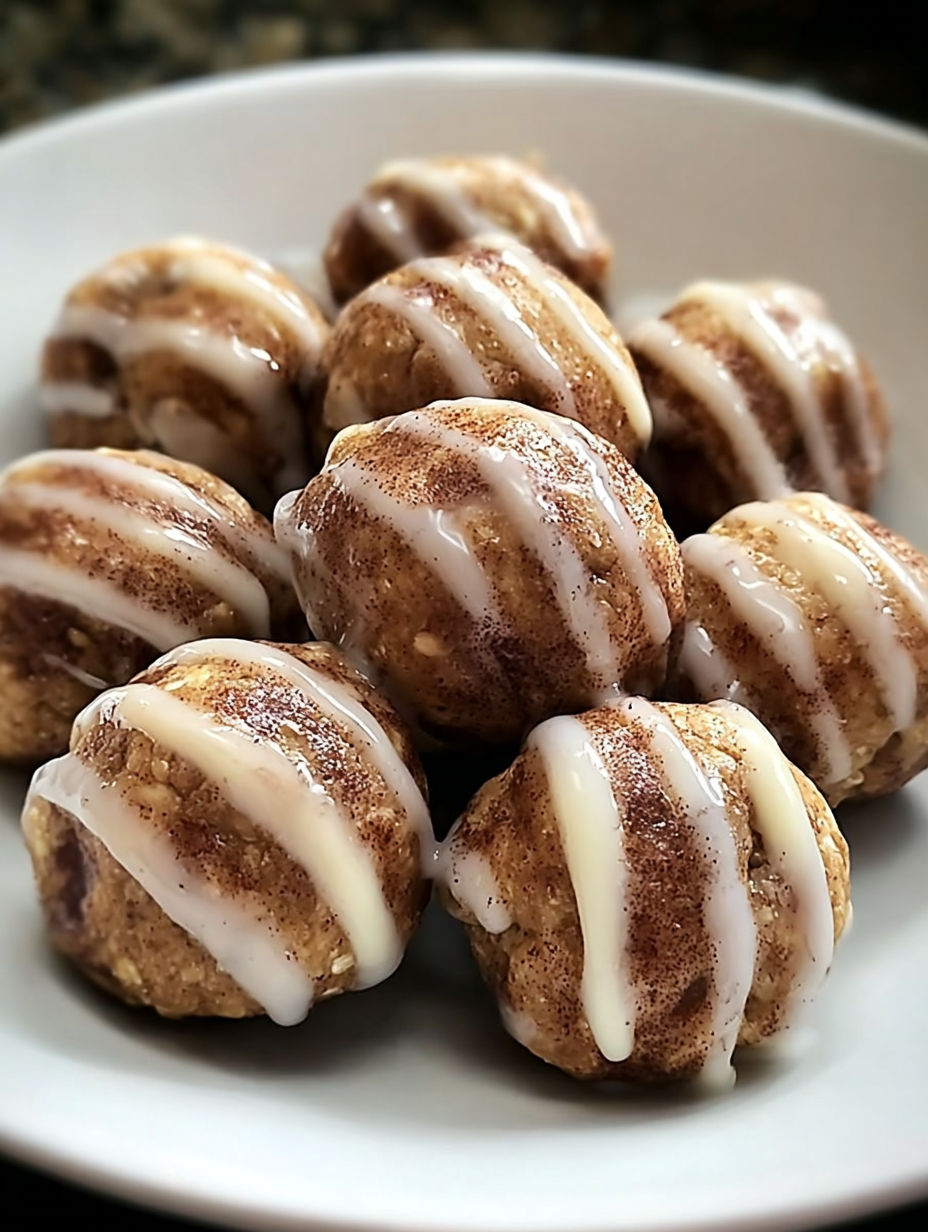 Cinnamon roll protein bites on a plate.