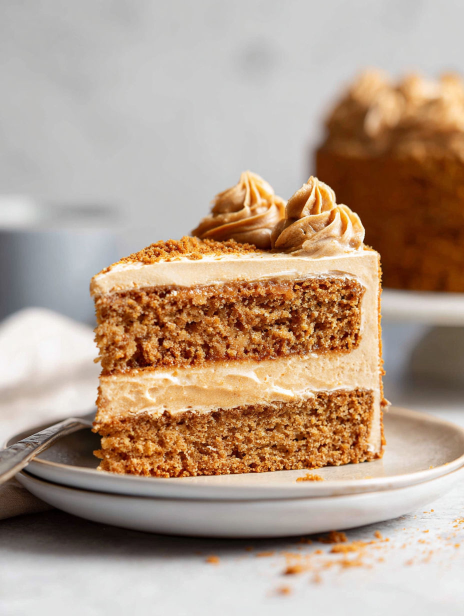 A slice of Biscoff cake on a plate.