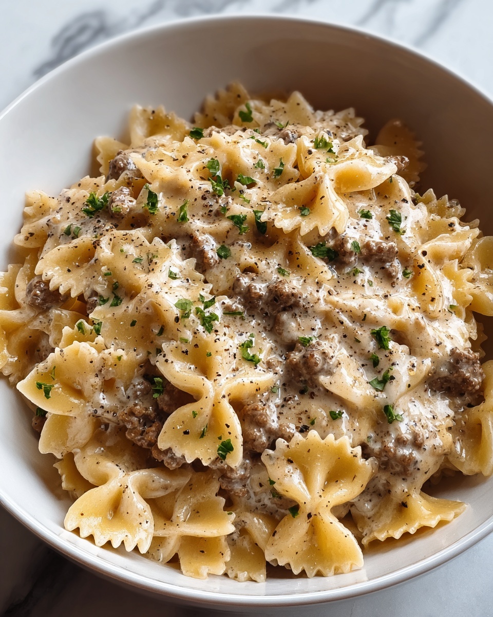 A bowl of creamy Parmesan garlic beef bowtie pasta.