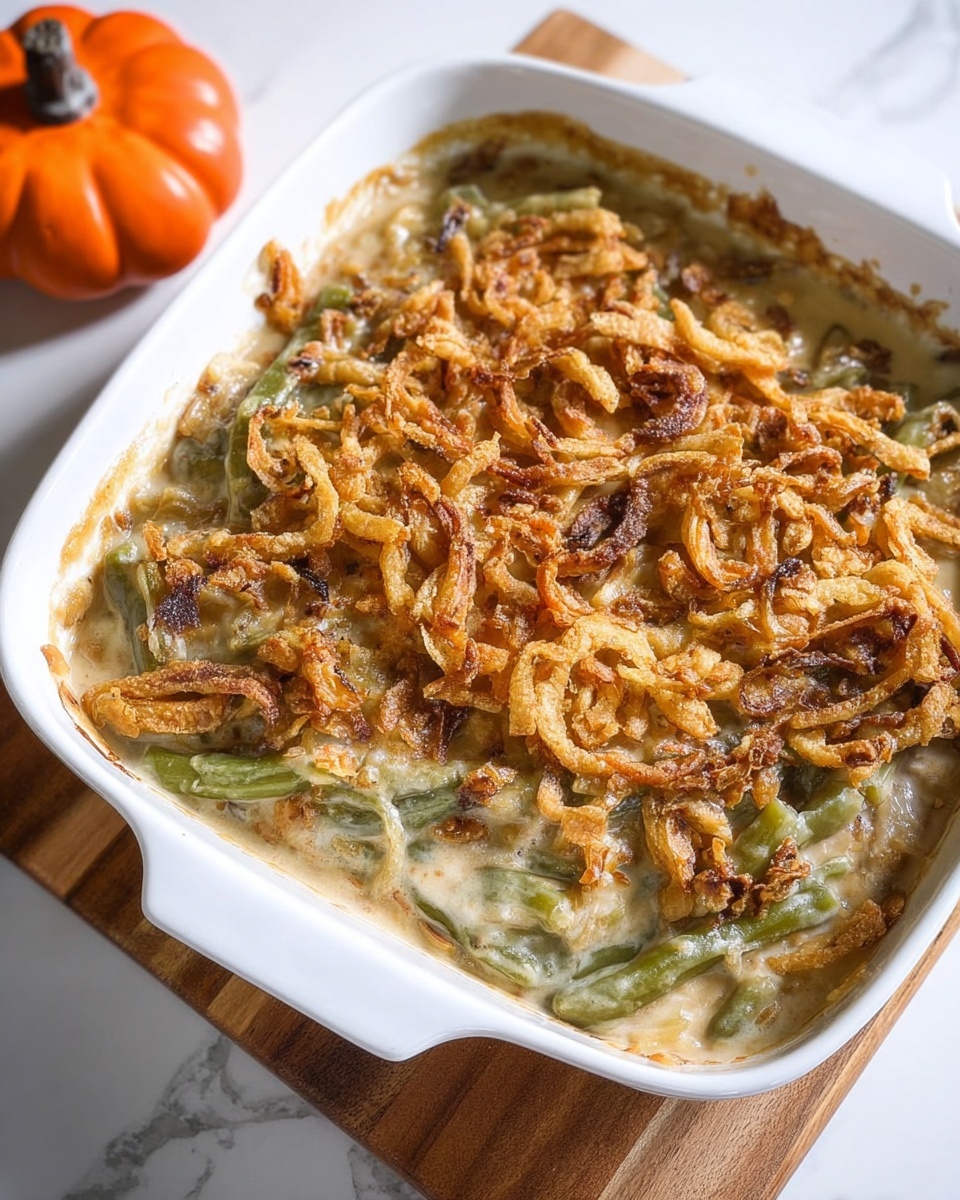 A white bowl filled with a green bean casserole.