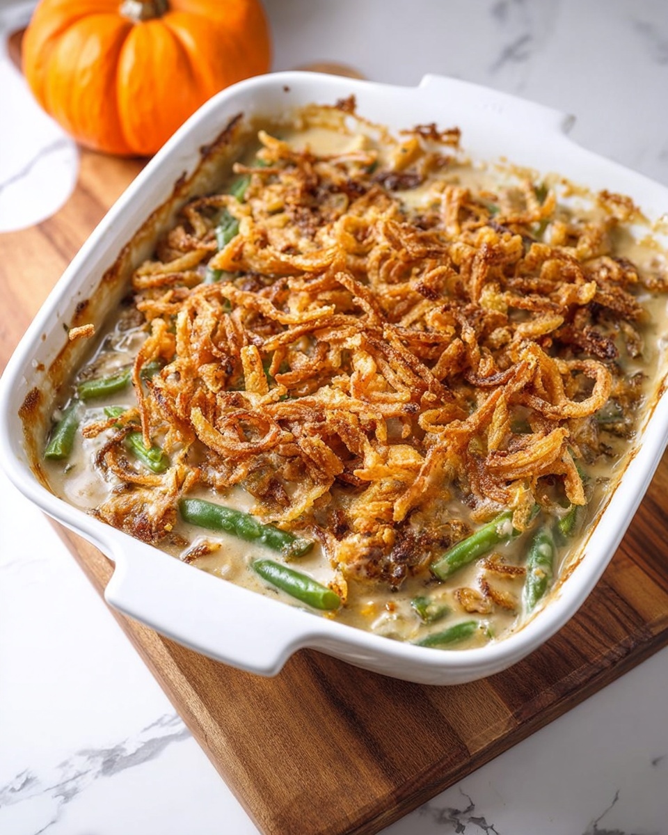 A white bowl of food with a green bean casserole.