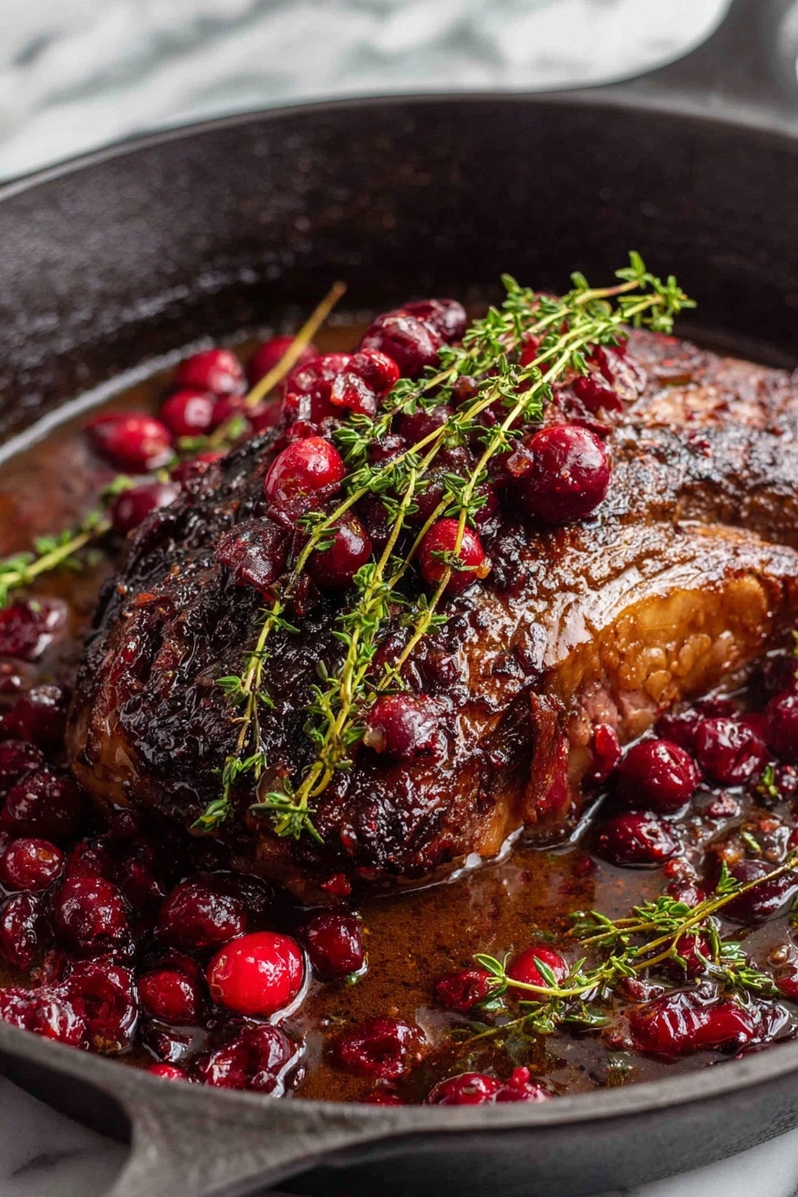 A roast beef with cranberries and herbs.