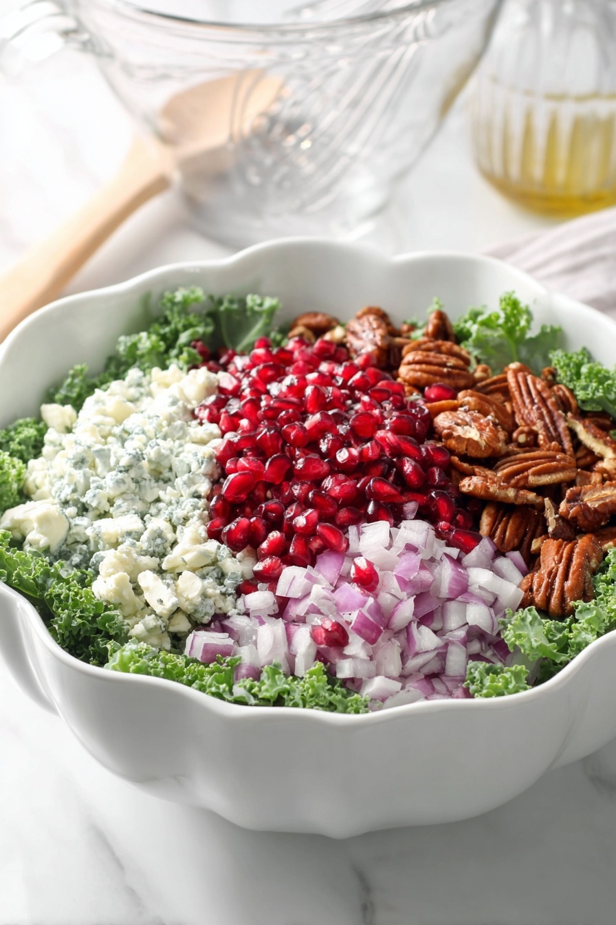 A bowl of salad with pomegranate, onions, and walnuts.