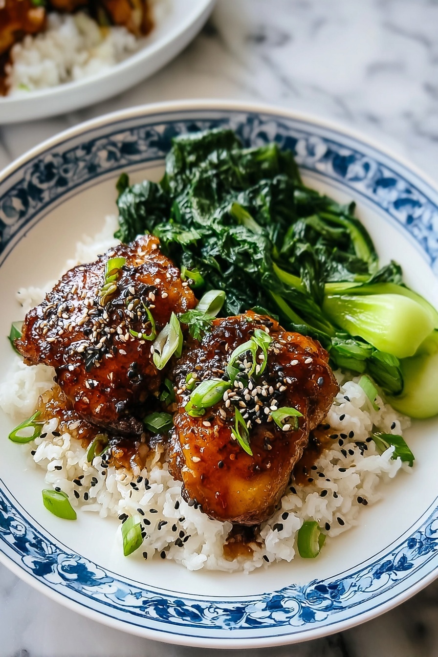 A plate of food with rice, chicken, and greens.