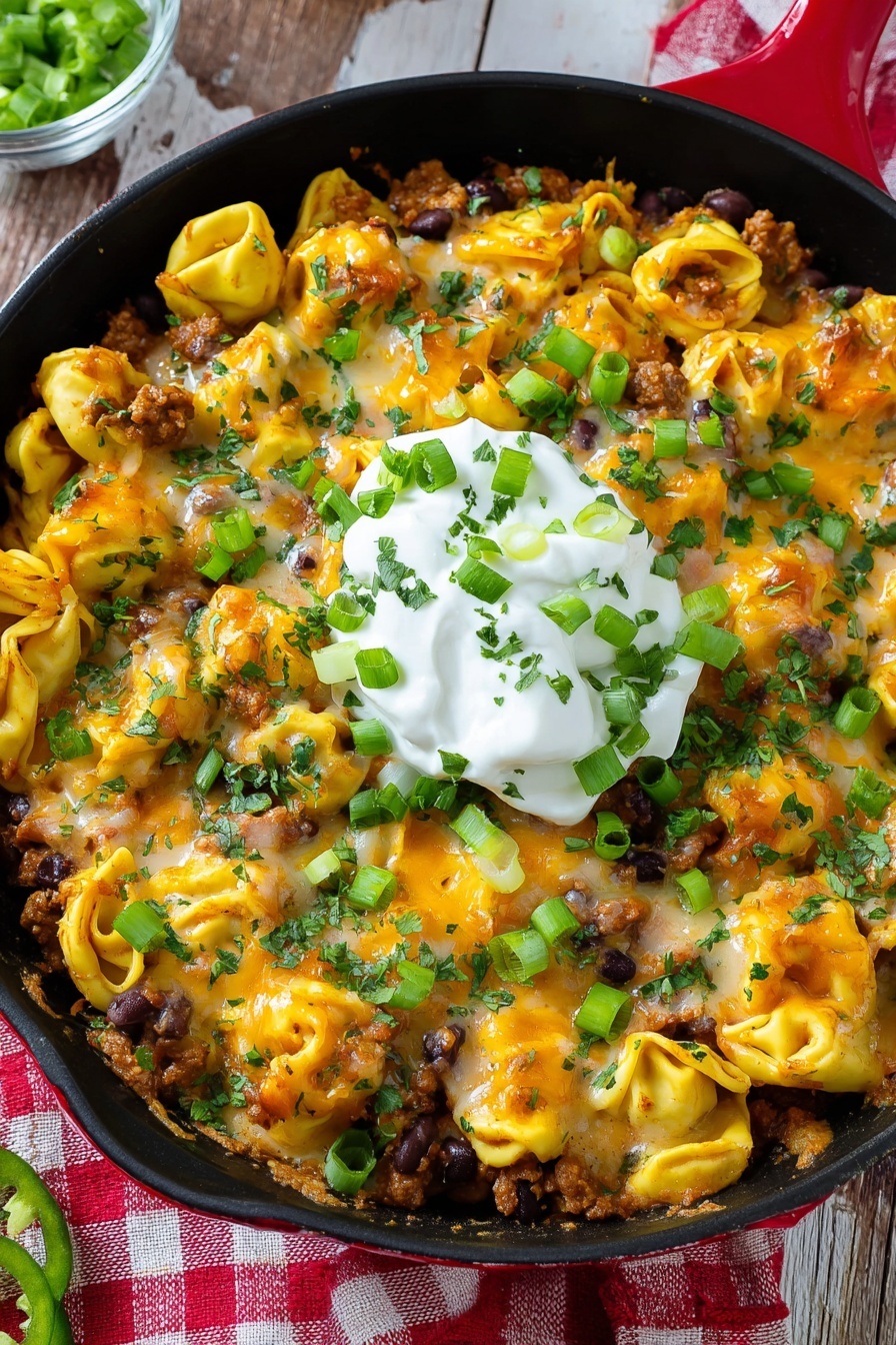 A skillet filled with cheesy beef enchilada tortellini.
