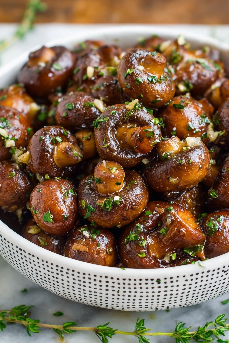 A bowl of mushrooms with garlic and balsamic sauce.