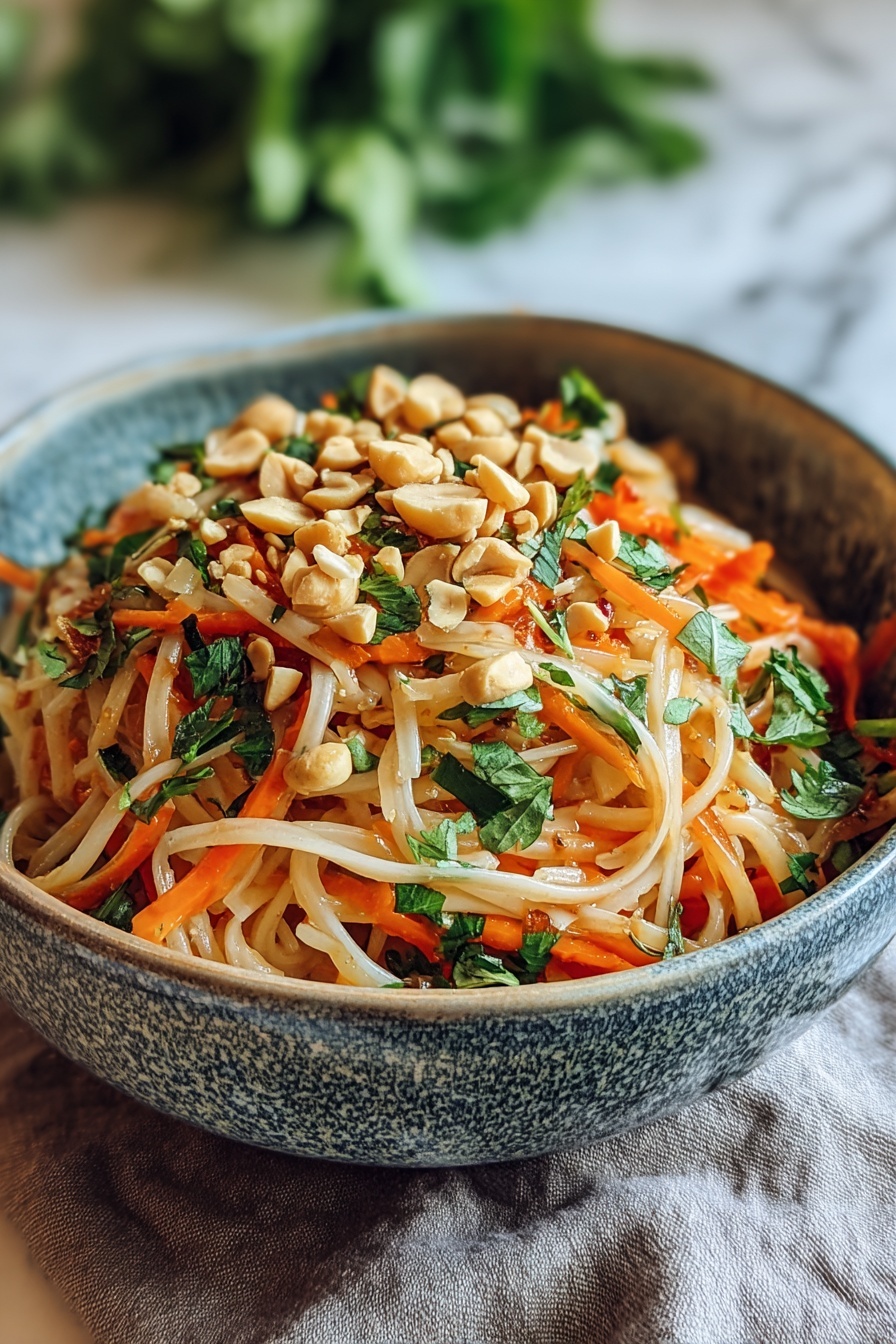 A bowl of Thai Peanut Carrot Noodles with a Twist.