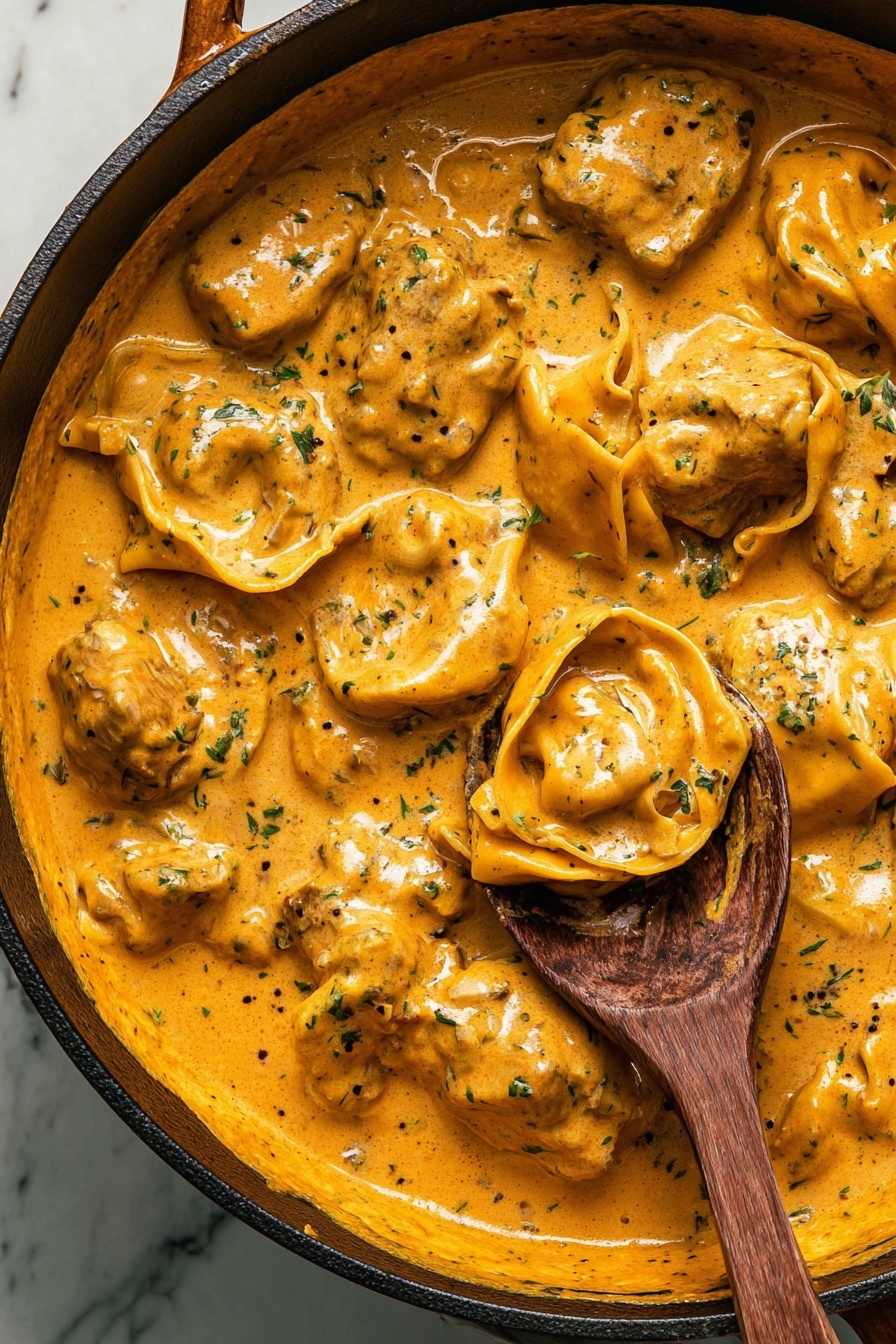 A bowl of creamy blackened chicken with tortellini.