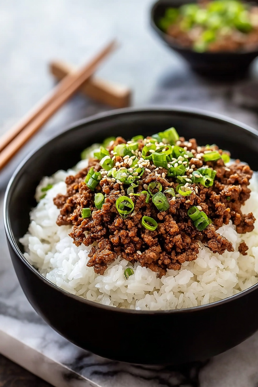 A bowl of beef with green onions.