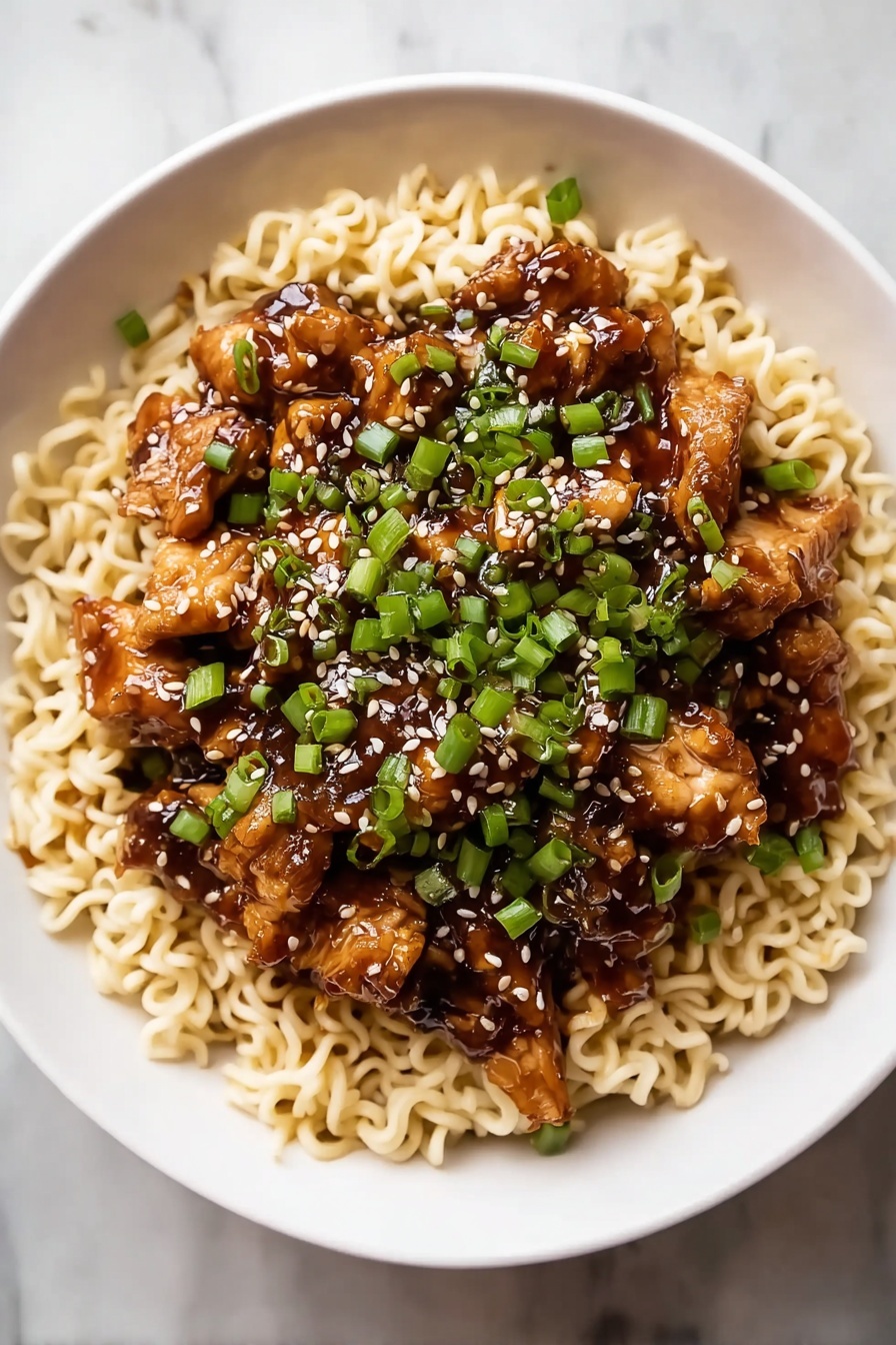 A bowl of Kung Pao Chicken Noodles.