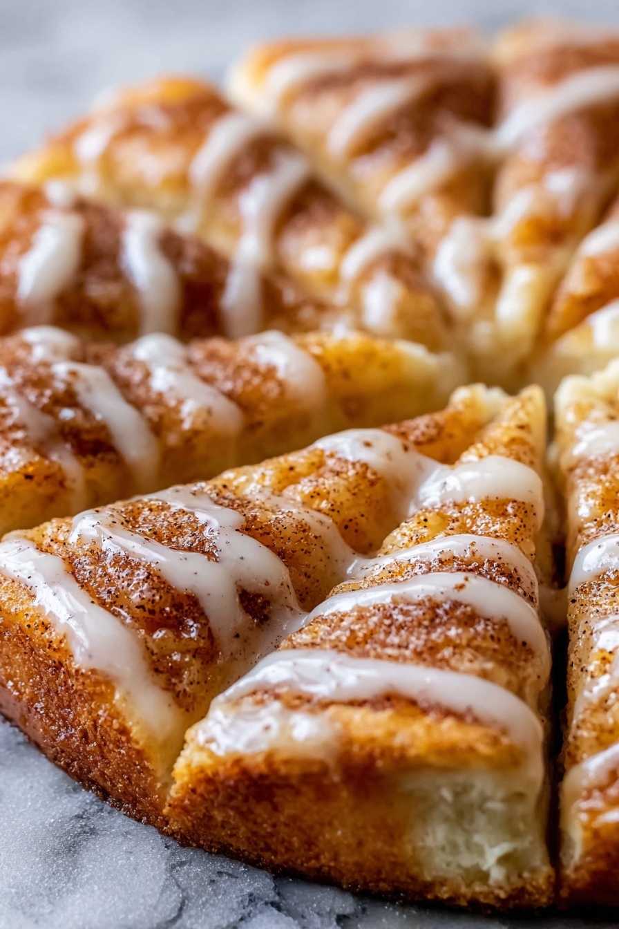 A close up of a cinnamon-sugar pizza made with crescent rolls.