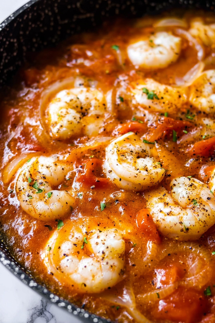 A bowl of shrimp cacciatore with rice.