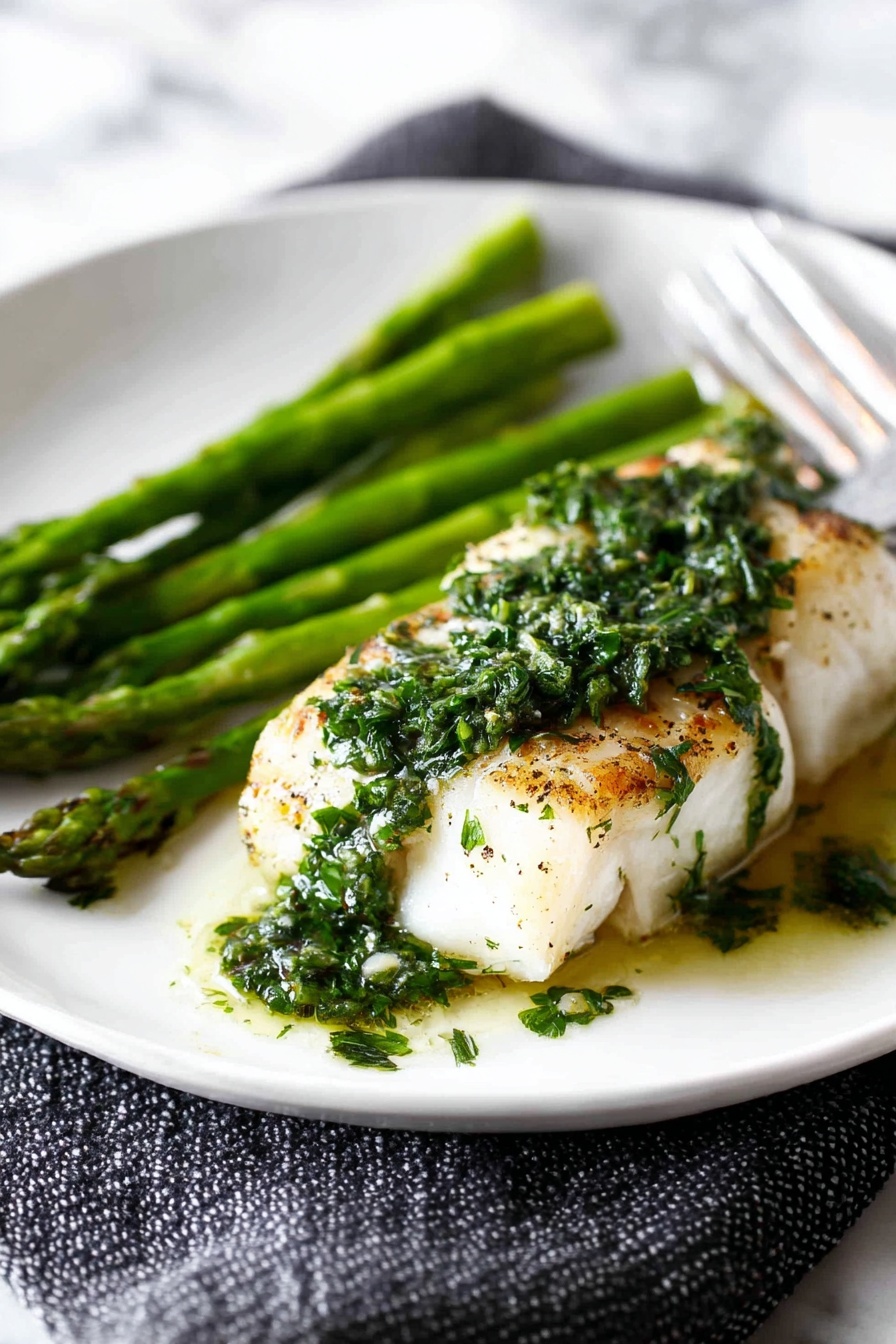 A plate of grilled fish with lemon butter.