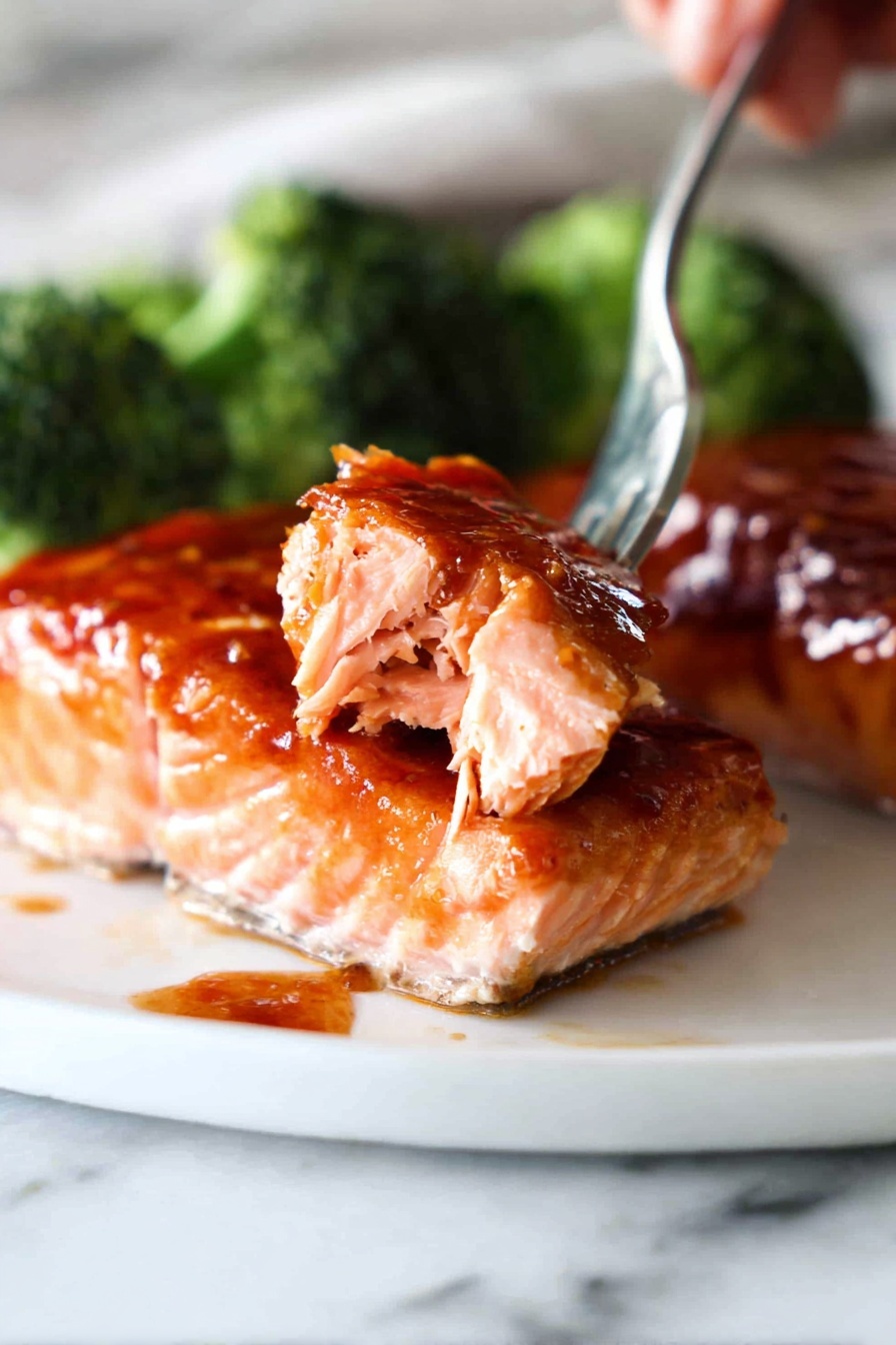 A piece of salmon with a fork in it.