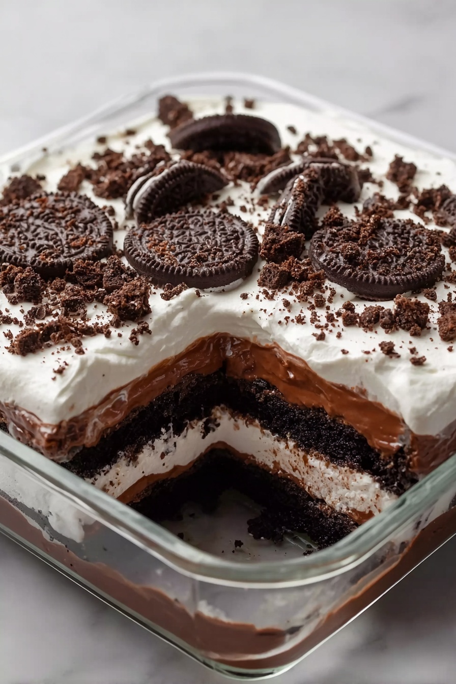 A slice of chocolate cake with Oreo cookies on top.
