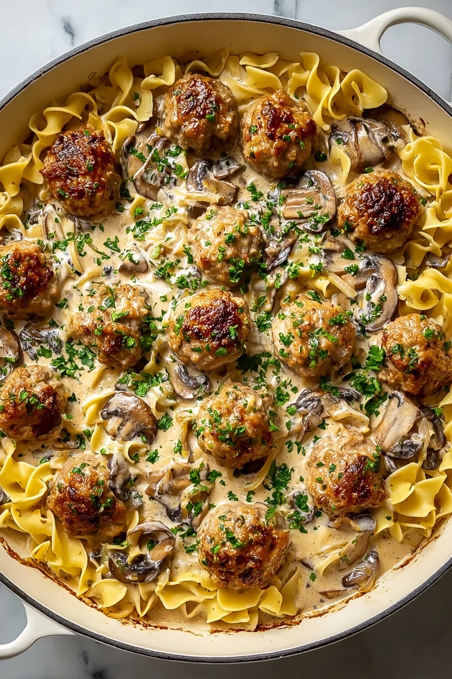 A dish of meatballs covered in mushrooms and sauce.