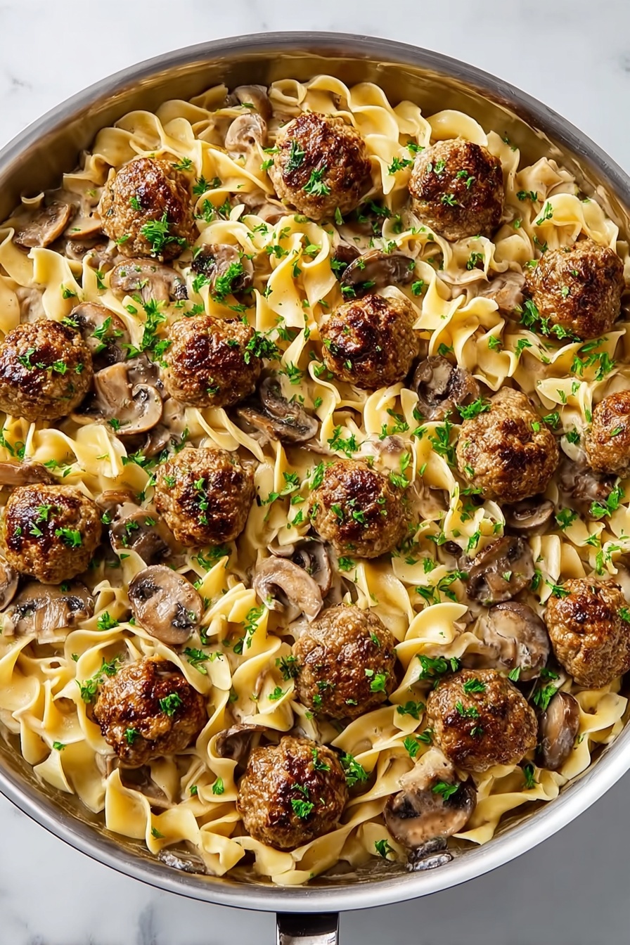 A plate of meatballs and noodles.