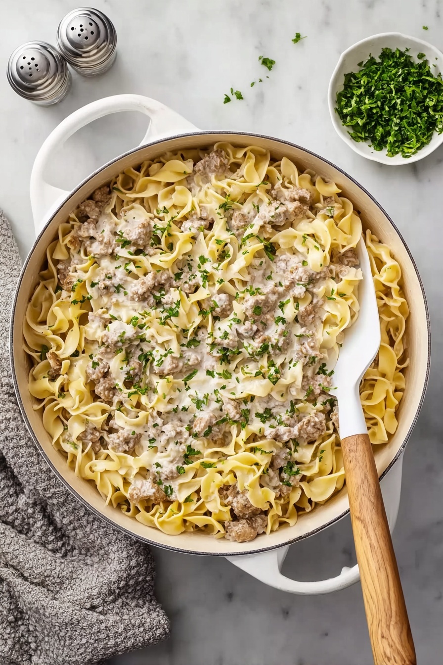 A bowl of pasta with meat and cheese.