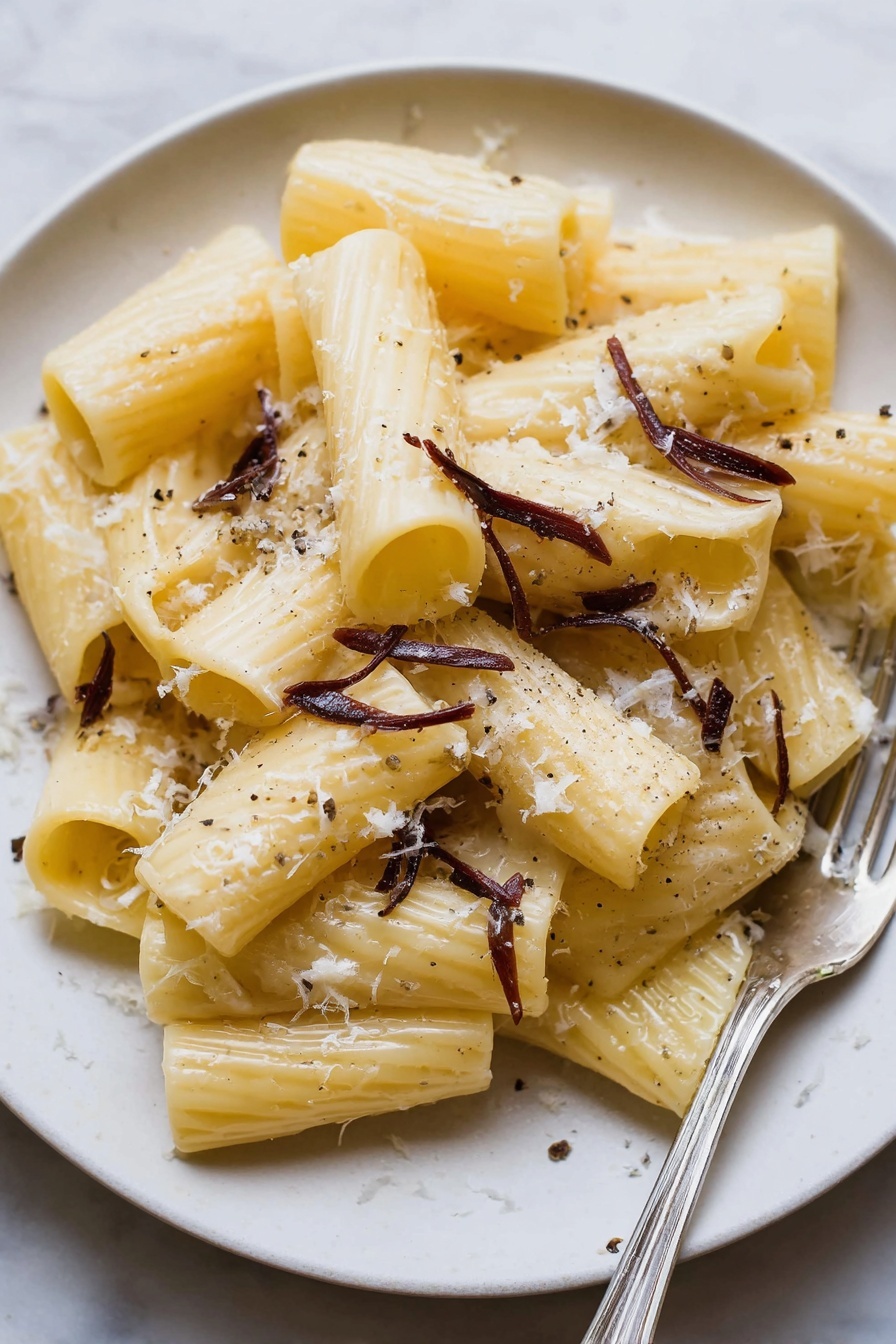 A plate of pasta with cheese and herbs.
