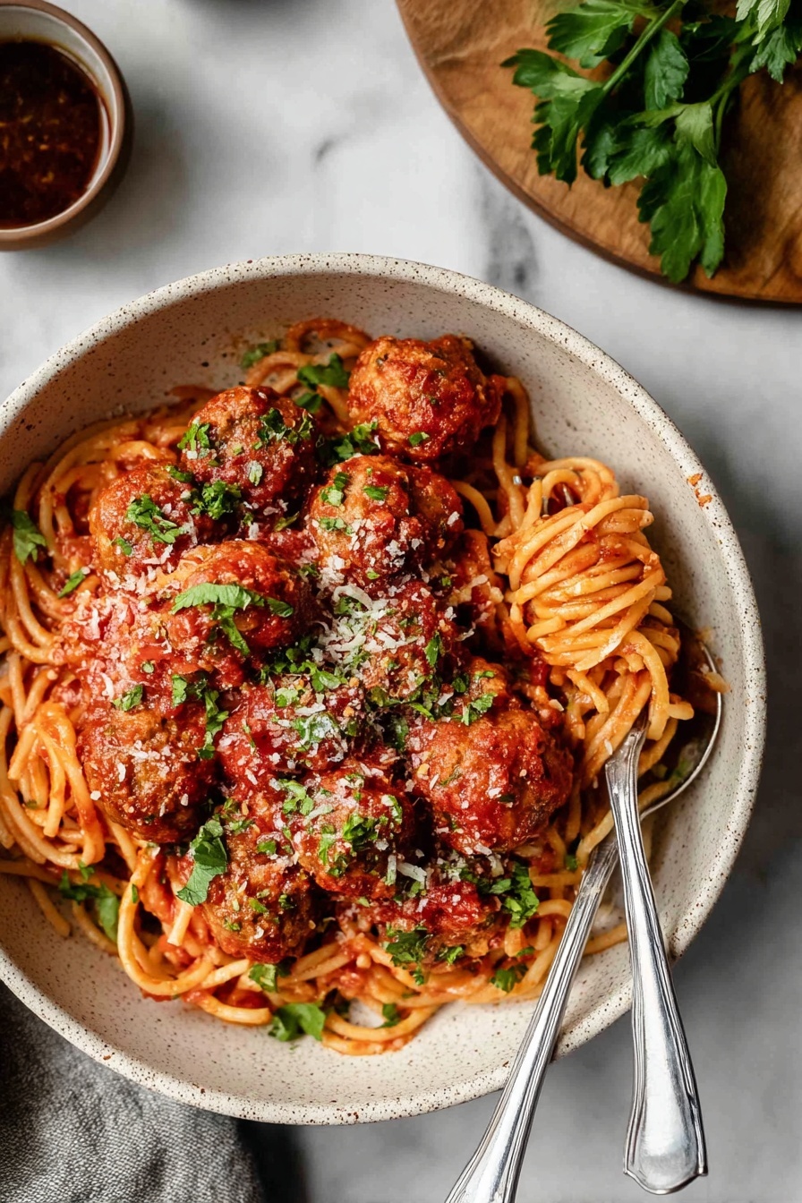 A bowl of meatballs with spaghetti.