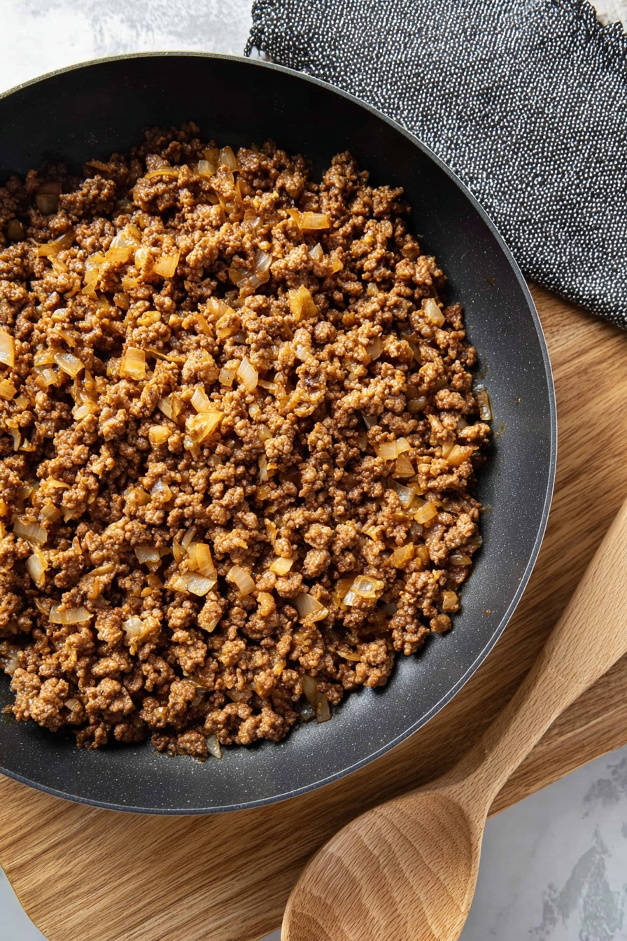 A bowl of ground beef with onions.