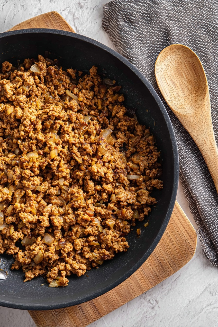 A bowl of ground beef with onions.