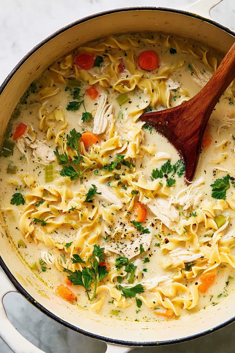 A bowl of creamy chicken noodle soup.