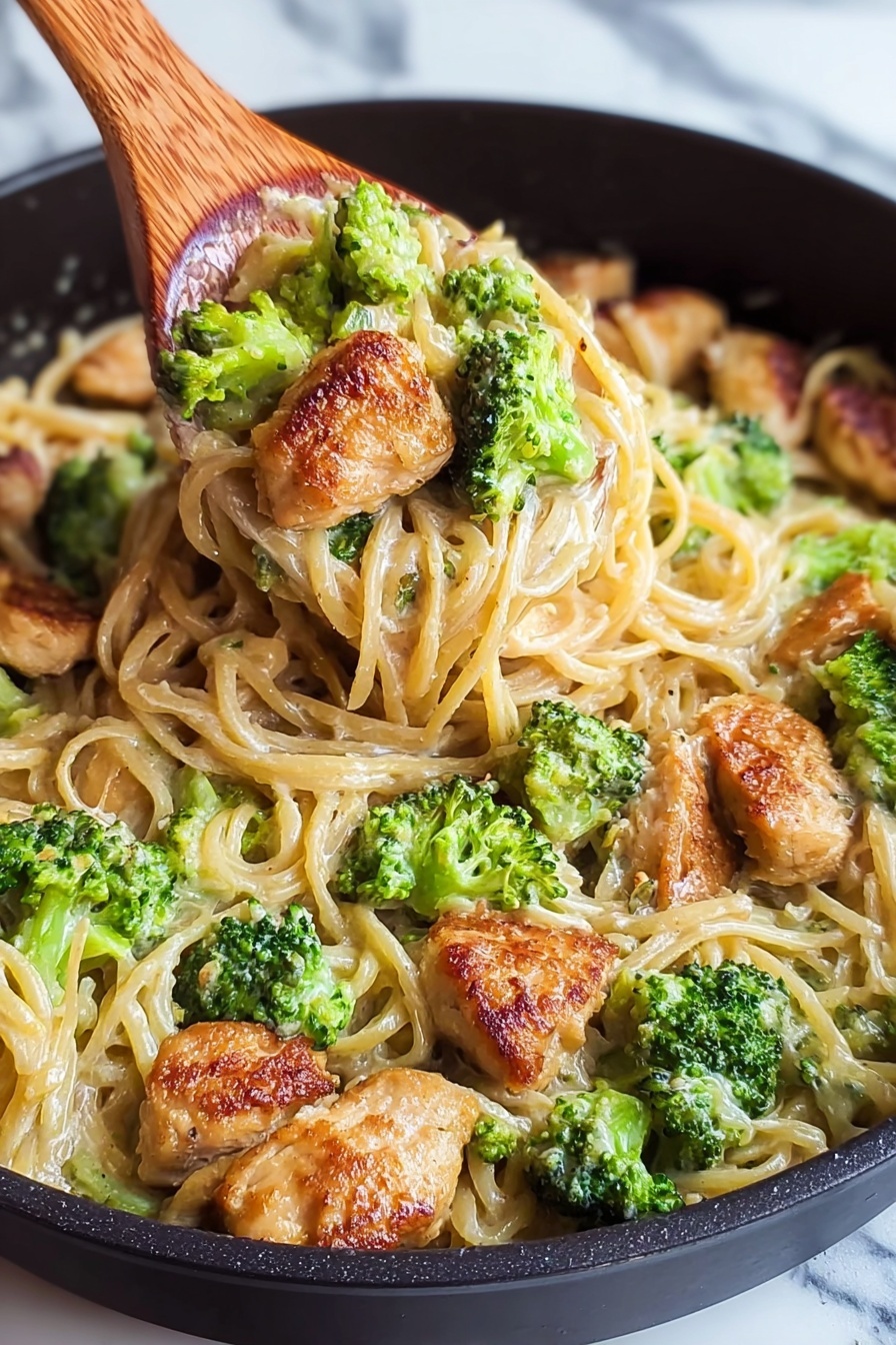 A bowl of pasta with chicken and broccoli.