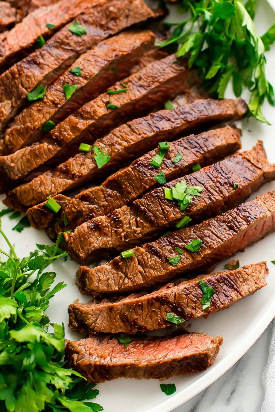 A plate of London Broil with green onions on top.