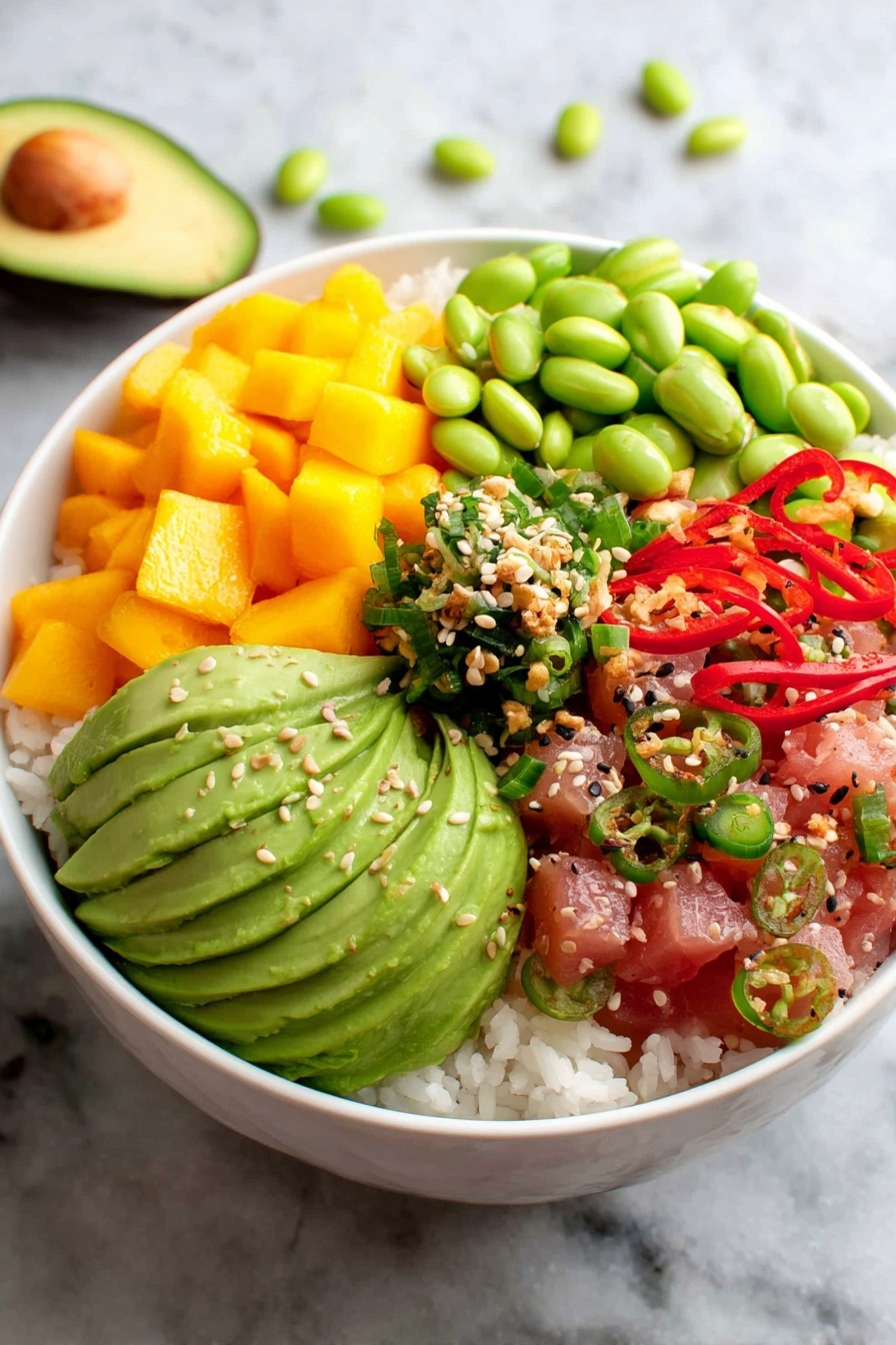 A bowl of food with ahi tuna, avocado, green beans, and red peppers.